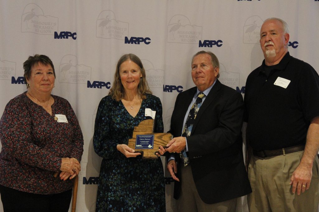 Chrysa Niewald was presented with an Outstanding Community Service Award by MRPC Board Chair Mary Heywood (left) and Vice Chair Darryl Griffin (second right) at the 2024 Annual Dinner and Awards Banquet on Oct. 24 in Linn. She was nominated by Owensville Mayor Kevin McFadden (right). 