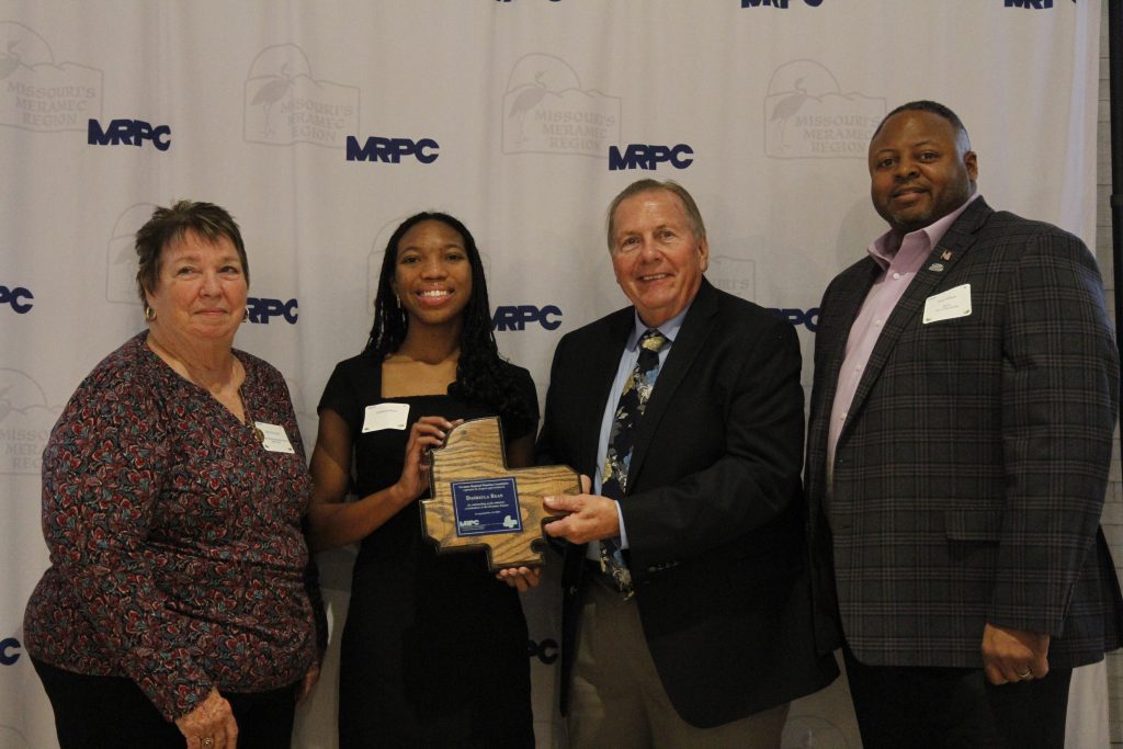  Dashayla Bean of Waynesville, was presented with an Youth Outstanding Community Service Award, by MRPC Board Chair Mary Heywood (left) and Vice Chair Darryl Griffin (second right) at the 2024 Annual Dinner and Awards Banquet on Oct. 24 in Linn. Bean was nominated by Waynesville Mayor Sean Wilson (right). 