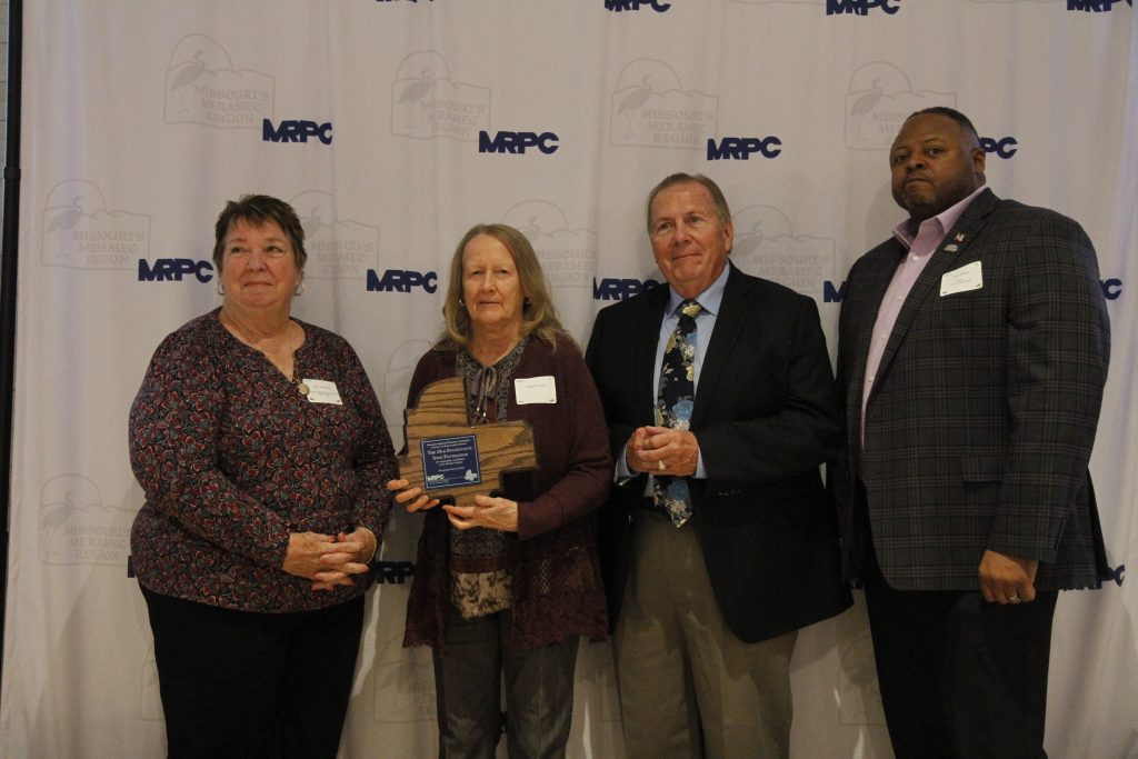 The Old Stagecoach Stop Foundation was presented with an Outstanding Community Service Award by MRPC Board Chair Mary Heywood (left) and Vice Chair Darryl Griffin (second right) at the 2024 Annual Dinner and Awards Banquet on Oct. 24 in Linn. The foundation was nominated by Waynesville Mayor Sean Wilson (right). Jeannie Porter accepted the award on its behalf.